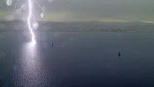 view from the air of lightening striking the water in Barcelona at America's Cup