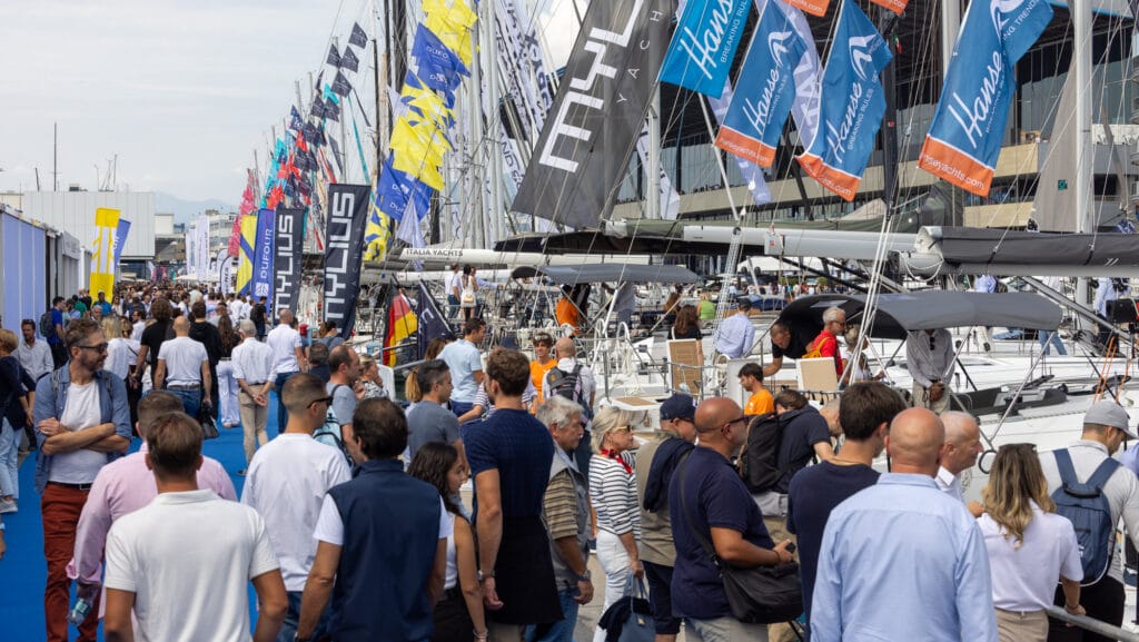 Visitors walking along pontoon at Genoa boat show