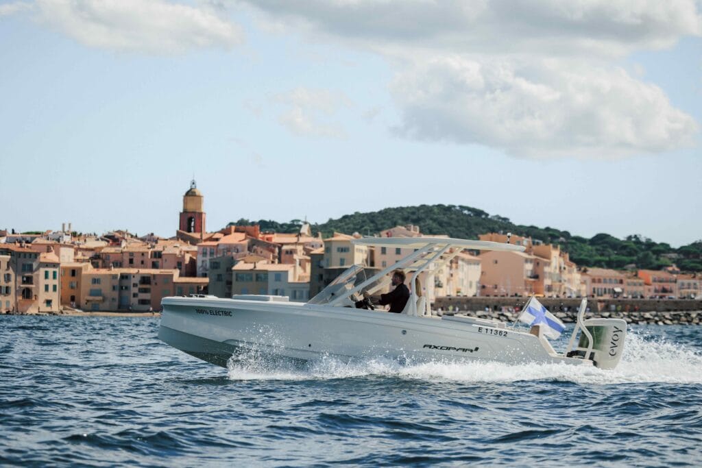 white luxury speedboat with old town in the background