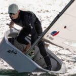 Man sailing on an Optimist - a small, single-handed sailing dinghy