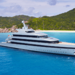 Luxury yacht pictured in distance on deep blue water as part of Feadship Resale strategy