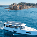 white motor boat with solar panels on pilothouse roof