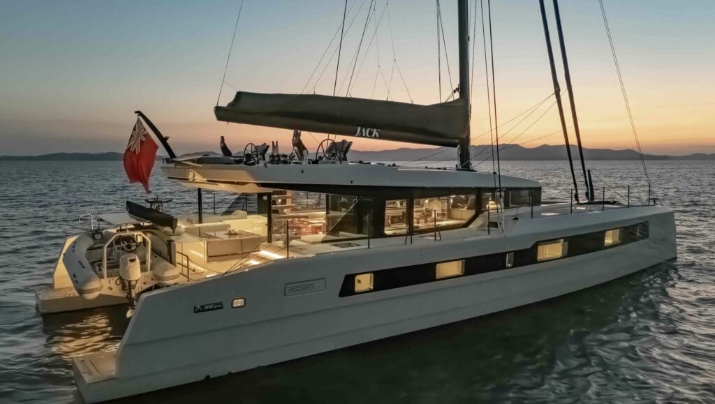 Side on shot of luxury sail catamaran at dusk