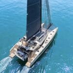 aerial shot of sailing catamaran on turquoise water