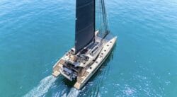 aerial shot of sailing catamaran on turquoise water