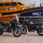 Two swanky motorbiked in front of RNLI vessels. Bikes donated by 007