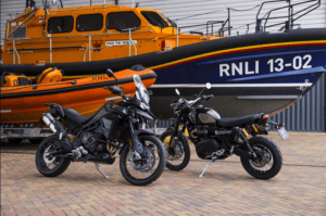 Two swanky motorbiked in front of RNLI vessels. Bikes donated by 007