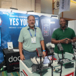 Two men at a boating show stand