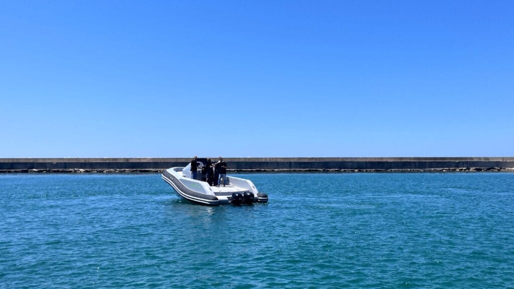 ExploMar electric outboard on boat on calm bright blue sea