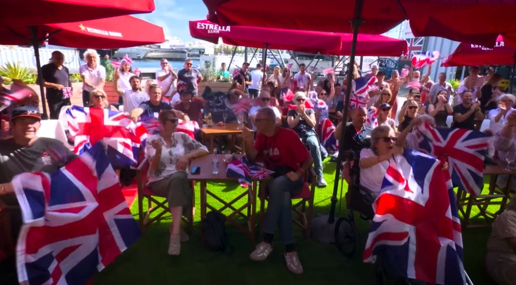 British flag waving crowd celebrating Ben Ainslie and his team in America's Cup contest