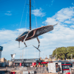 INEOS Britannia being craned in for America's Cup racing