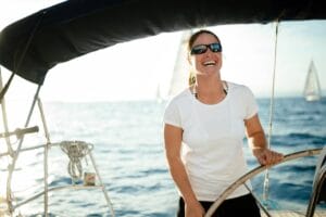 Woman at the helm of a sailing boat