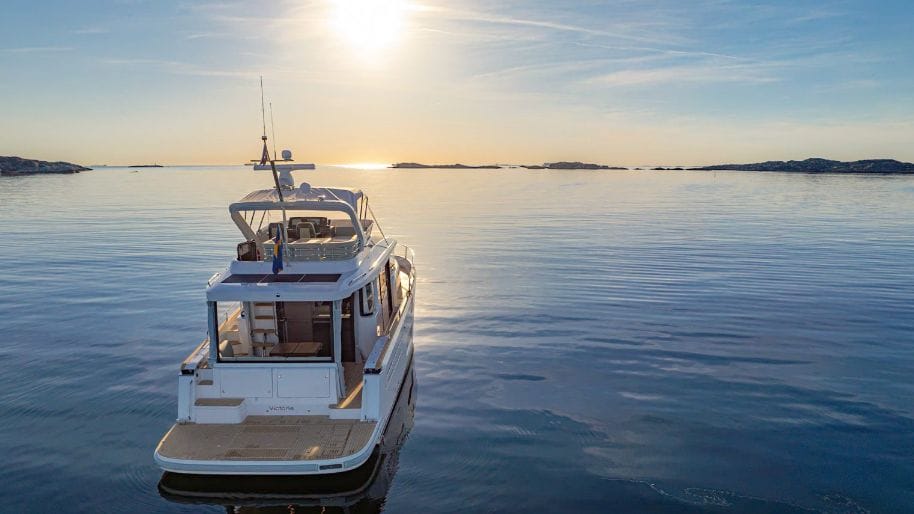 stern of Nimbus 495 Flybridge in sunset on calm waters