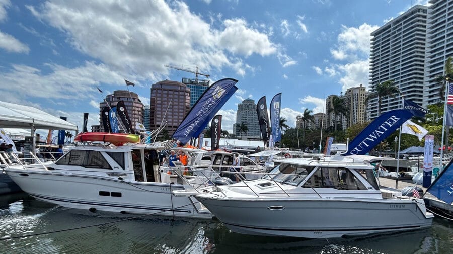 Two motor boats on display with flags in background