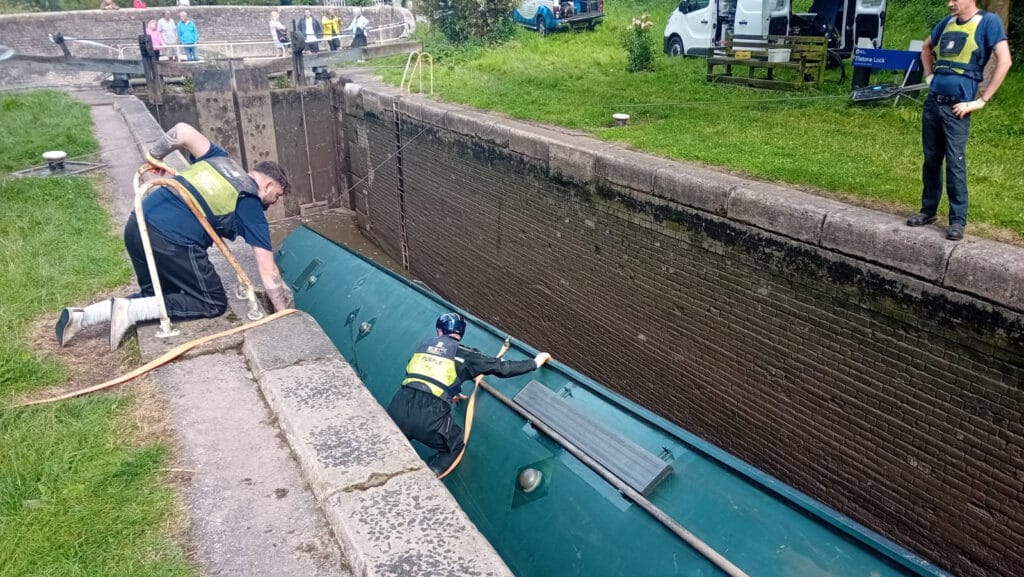 River Canal Rescue team members rescue overturned boat in lock