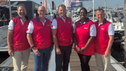 The team from Salt wear red gilets and stand on a pontoon