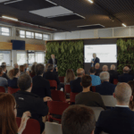 Conference room of people watching presentation on green methanol bi-fuel superyacht