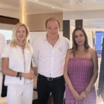 five smart/casual businessmen and women posing for a photo