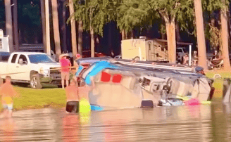 People attempt to drag Sea-Doo Switch out of water with a truck after it flipped