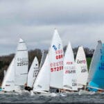 A fleet of small sailing boats on the water