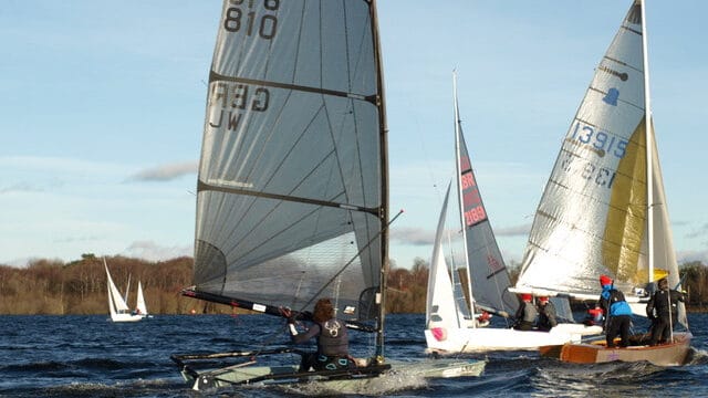 A fleet of small sailing boats on the water