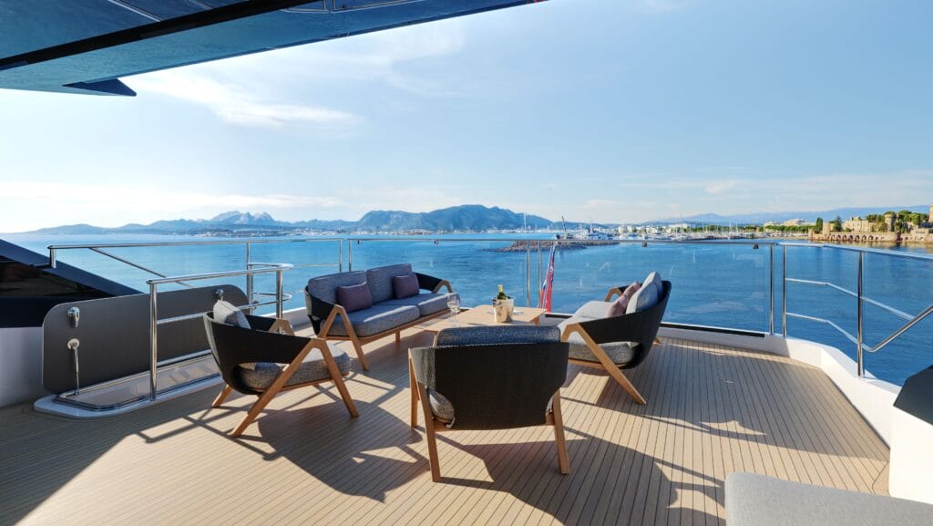 Stern of Sunseeker 94 Yacht with table and chairs and lovely view of water and islands