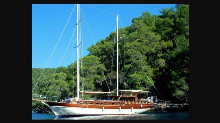 Boat at anchor under azure sky. This is one of Boatsy's yacht rentals available in boat tourism boom