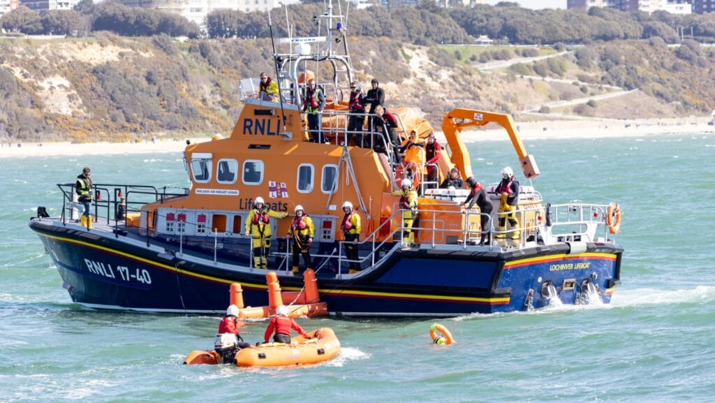 Mass rescue training event in Poole Bay, Dorset on 20the April 2023. Mass simulation event testing of self rescue equipment during a mass rescue in response to the rescue of migrants crossing the English Channel. RNLI lifeguards acted as casualties and were rescued by volunteer crew members by a Shannon, Severn and Atlantic 85 B-class inshore lifeboat.