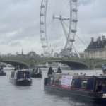 A flotilla of boats passes trhough London highlighting the need to Fund Britain's Waterways