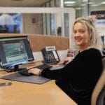 Blonde women sitting at desk with computer