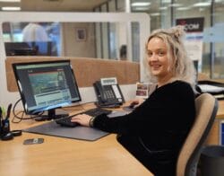 Blonde women sitting at desk with computer