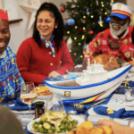 family sitting at christmas dinner table with large gravy boat