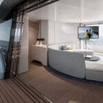 Superyacht interior with Sea 7 Symphony work on display - TV in white lounge