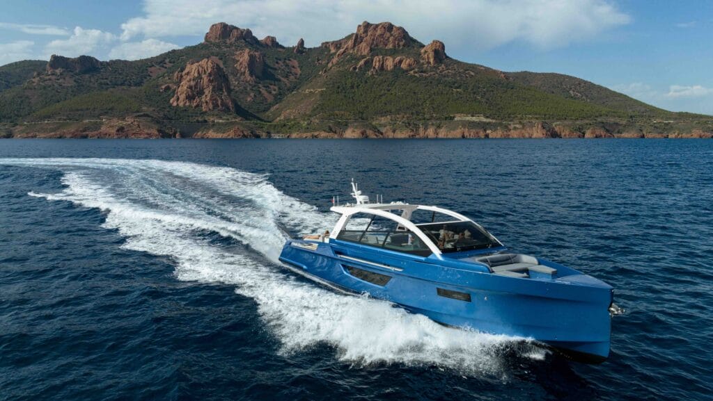 Sialia Yacht cruising across blue water with mountains in background