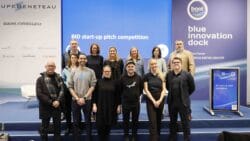 Group standing in front of Blue Innovation Dock stage