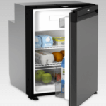 A Dometic boat refrigerator with door open showing eggs and produce inside