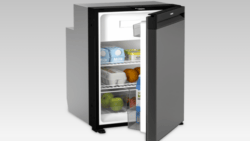 A Dometic boat refrigerator with door open showing eggs and produce inside