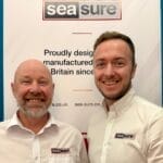 Graham Brown & Dan Henderson from Sea Sure stand in front of a Sea Sure sign