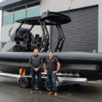 two men in front of a hydrogen powered RIB