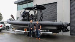 two men in front of a hydrogen powered RIB