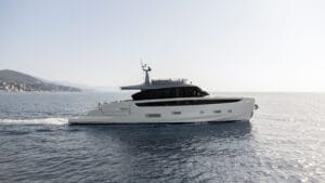 a side view of a white yacht on the water