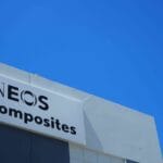 Factory hanger with blue sky above. Factory shows Ineos Composites signage