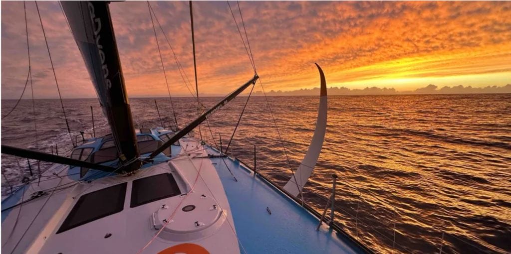 Vendée Globe boat with sunrise behind