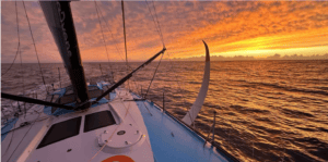 Vendée Globe boat with sunrise behind