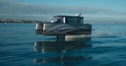 A small ferry on hydrofoil glides across smooth sea