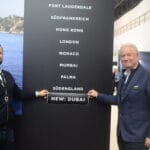 Two men by Ocean Independence signage